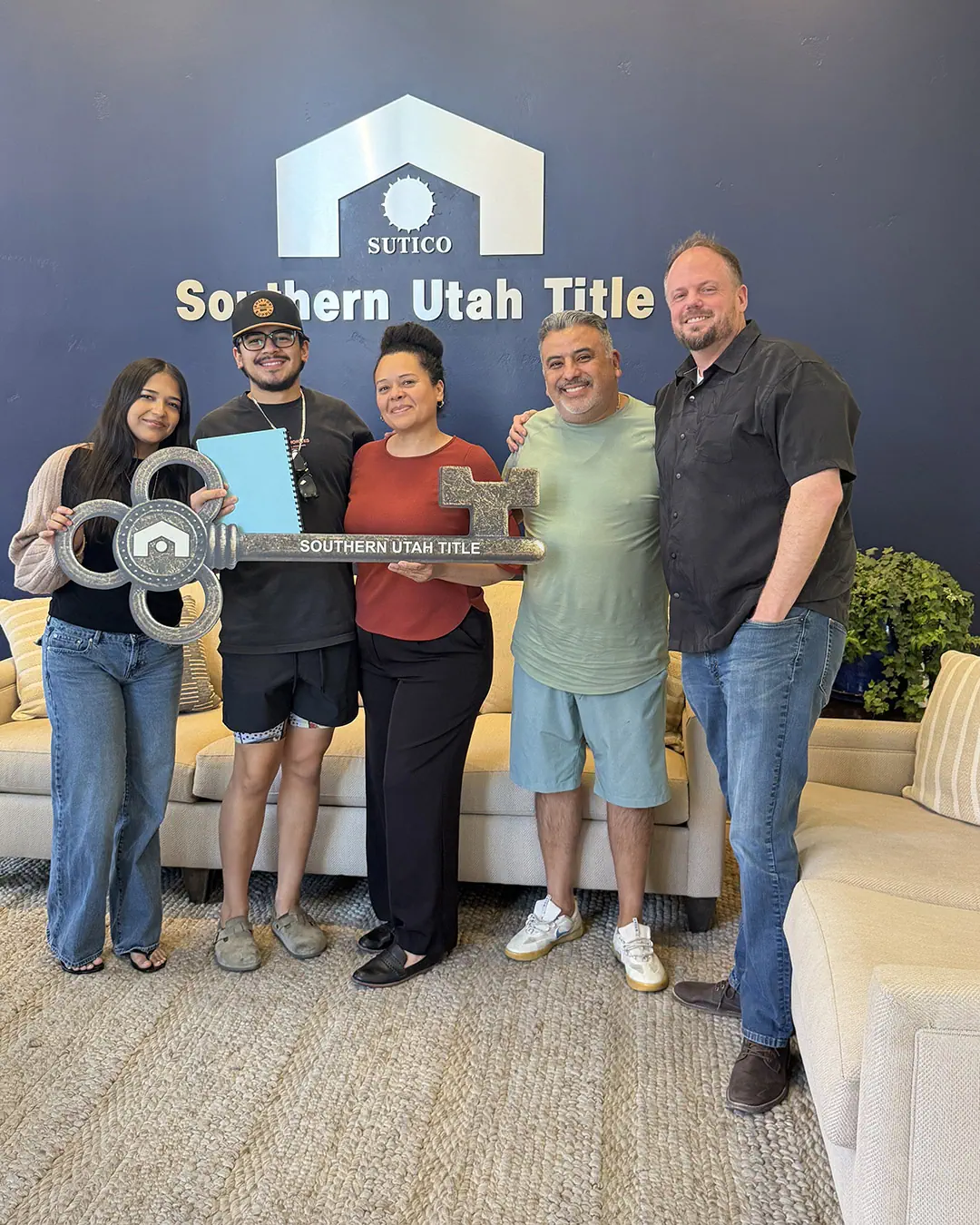 Scott Buehler with Erick and Carmen celebrating the purchase of their new construction home.